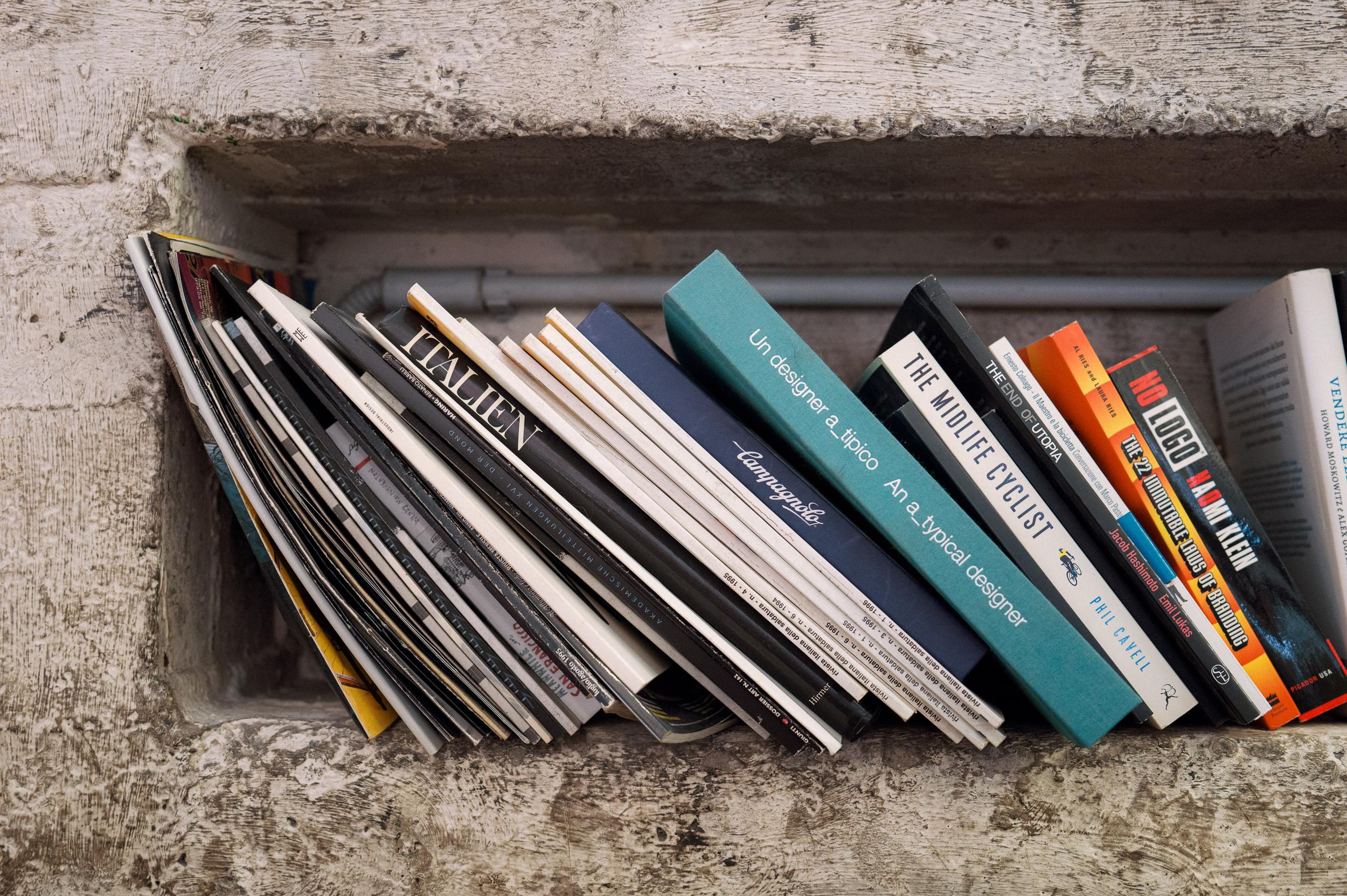 Books and magazines on a concrete ledge at the Bottega